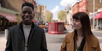 Movie still from “Ted Lasso” (2020), created by Brendan Hunt – A man and a woman standing on the side of the street; Medium shot, Over the shoulder angle
