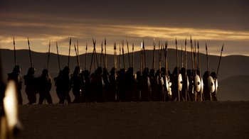 Movie still from “Game of Thrones” (2011), created by D.B. Weiss – A group of people standing next to each other on a beach; Extreme Wide shot, High angle