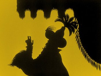 Movie still from “The Adventures of Prince Achmed” (1926), directed by Lotte Reiniger – A shadow of a person holding a palm tree in front of a palm tree; Extreme Close Up shot, Low angle