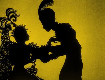 Movie still from “The Adventures of Prince Achmed” (1926), directed by Lotte Reiniger – A silhouette of a woman and a man holding hands; Medium shot, Low angle