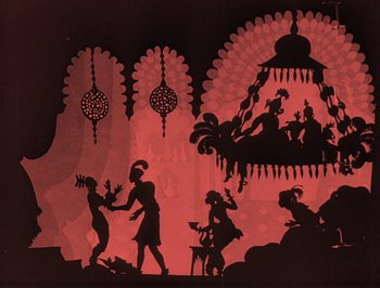 Movie still from “The Adventures of Prince Achmed” (1926), directed by Lotte Reiniger – A group of silhouetted people standing in front of a red background; Extreme Wide shot, Low angle