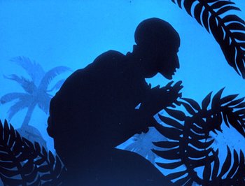 Movie still from “The Adventures of Prince Achmed” (1926), directed by Lotte Reiniger – A man kneeling down in front of some plants; Medium shot, Low angle