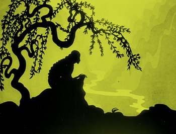 Movie still from “The Adventures of Prince Achmed” (1926), directed by Lotte Reiniger – A silhouette of a person sitting under a tree near a body of water; Wide shot, Low angle