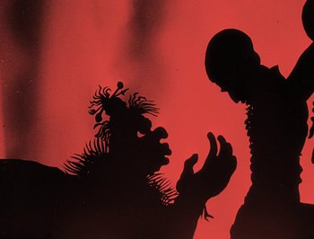 Movie still from “The Adventures of Prince Achmed” (1926), directed by Lotte Reiniger – A shadow of a man and a clown on a red background; Close Up shot, Low angle