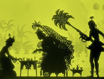 Movie still from “The Adventures of Prince Achmed” (1926), directed by Lotte Reiniger – A shadow of a woman sitting on a chair with a man holding an umbrella; Wide shot, Low angle