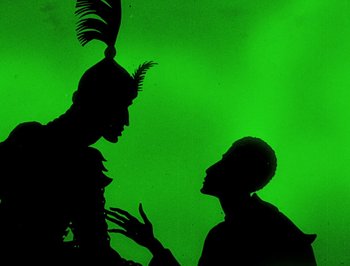 Movie still from “The Adventures of Prince Achmed” (1926), directed by Lotte Reiniger – A man and a woman talking to each other; Medium shot, Low angle