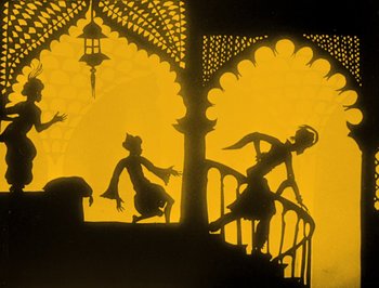 Movie still from “The Adventures of Prince Achmed” (1926), directed by Lotte Reiniger – A shadow of a man and a woman on a balcony; Wide shot, Low angle