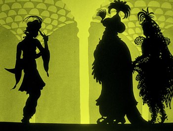 Movie still from “The Adventures of Prince Achmed” (1926), directed by Lotte Reiniger – Shadow puppets of a man and two other people; Wide shot, Low angle
