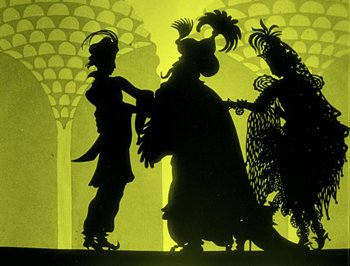 Movie still from “The Adventures of Prince Achmed” (1926), directed by Lotte Reiniger – A group of people standing next to each other on a stage; Wide shot, Low angle