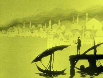 Movie still from “The Adventures of Prince Achmed” (1926), directed by Lotte Reiniger – A man standing in the water next to a boat; Extreme Wide shot, Low angle