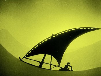Movie still from “The Adventures of Prince Achmed” (1926), directed by Lotte Reiniger – A person sitting on a boat in the sun; Extreme Wide shot, Low angle