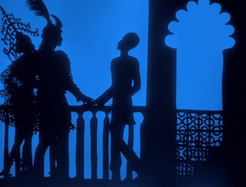 Movie still from “The Adventures of Prince Achmed” (1926), directed by Lotte Reiniger – A couple of people standing next to a railing; Wide shot, Low angle