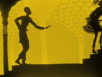 Movie still from “The Adventures of Prince Achmed” (1926), directed by Lotte Reiniger – A silhouette of a man standing in front of a tree; Wide shot, Low angle