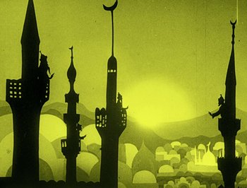 Movie still from “The Adventures of Prince Achmed” (1926), directed by Lotte Reiniger – A painting of a city with a person sitting on top of a building; Extreme Wide shot, Low angle