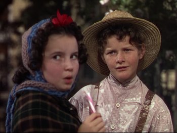 Movie still from “The Adventures of Tom Sawyer” (1938), directed by Norman Taurog – Two young girls are dressed up and one is holding a toothbrush in her hand; Close Up shot, High angle