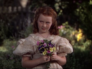 Movie still from “The Adventures of Tom Sawyer” (1938), directed by Norman Taurog – A young girl holding a bouquet of flowers; Close Up shot, High angle