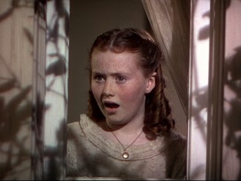 Movie still from “The Adventures of Tom Sawyer” (1938), directed by Norman Taurog – A young girl looking in a mirror with a surprised look on her face; Close Up shot, High angle