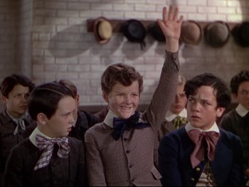 Movie still from “The Adventures of Tom Sawyer” (1938), directed by Norman Taurog – A group of young men standing next to each other; Medium shot, High angle