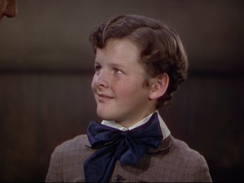 Movie still from “The Adventures of Tom Sawyer” (1938), directed by Norman Taurog – A young boy wearing a suit and bow tie; Close Up shot, High angle