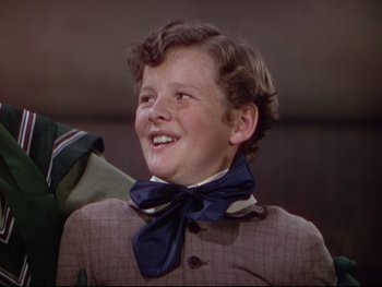 Movie still from “The Adventures of Tom Sawyer” (1938), directed by Norman Taurog – A young boy wearing a bow tie and a jacket; Close Up shot, High angle
