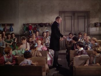 Movie still from “The Adventures of Tom Sawyer” (1938), directed by Norman Taurog – An old school classroom with a teacher and students; Wide shot, High angle