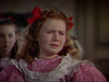 Movie still from “The Adventures of Tom Sawyer” (1938), directed by Norman Taurog – A little girl with red bows in her hair crying; Close Up shot, High angle
