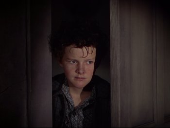 Movie still from “The Adventures of Tom Sawyer” (1938), directed by Norman Taurog – A young woman standing in a dark room looking at the camera; Close Up shot, High angle