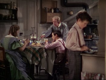 Movie still from “The Adventures of Tom Sawyer” (1938), directed by Norman Taurog – An old fashioned family gathering in a kitchen; Wide shot, High angle