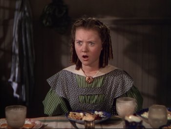Movie still from “The Adventures of Tom Sawyer” (1938), directed by Norman Taurog – A young woman sitting at a table in front of a plate of food; Close Up shot, High angle