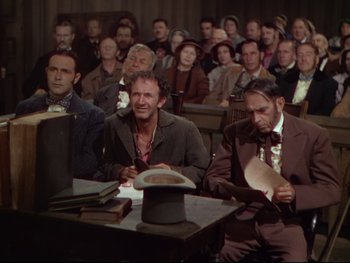Movie still from “The Adventures of Tom Sawyer” (1938), directed by Norman Taurog – A group of people sitting in a room; Medium shot, High angle