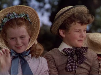 Movie still from “The Adventures of Tom Sawyer” (1938), directed by Norman Taurog – Two young children wearing hats sitting next to each other; Close Up shot, Low angle