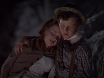 Movie still from “The Adventures of Tom Sawyer” (1938), directed by Norman Taurog – Two people are hugging each other in the dark; Close Up shot, Low angle