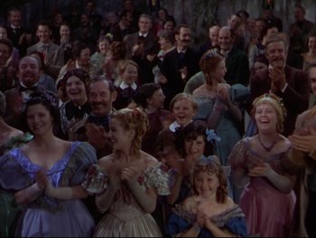 Movie still from “The Adventures of Tom Sawyer” (1938), directed by Norman Taurog – A group of people in fancy dress at an event; Medium shot, High angle