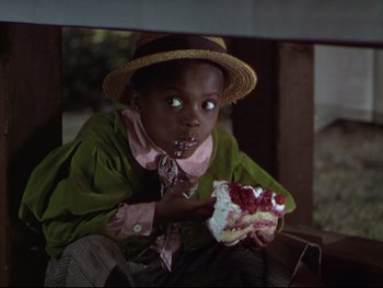 Movie still from “The Adventures of Tom Sawyer” (1938), directed by Norman Taurog – A young child eating a piece of cake; Close Up shot, High angle