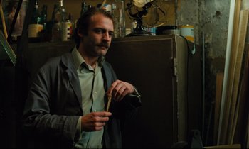 Movie still from “The American Friend” (1977), directed by Wim Wenders – A man standing in front of an open refrigerator; Medium shot, Low angle