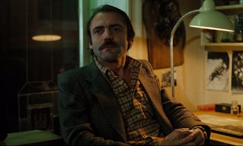 Movie still from “The American Friend” (1977), directed by Wim Wenders – A man sitting in front of a window in a room; Close Up shot, Low angle