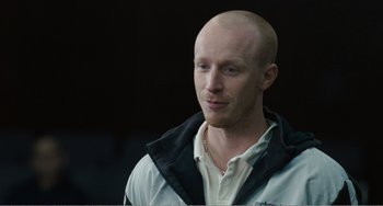 Movie still from “The Angels' Share” (2012), directed by Ken Loach – A man with a bald head is looking to his left; Close Up shot, High angle