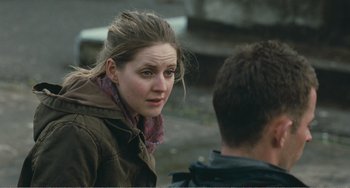 Movie still from “The Angels' Share” (2012), directed by Ken Loach – A young woman standing in front of a man; Close Up shot, Over the shoulder angle