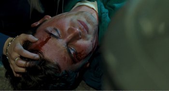 Movie still from “The Angels' Share” (2012), directed by Ken Loach – A man laying on the ground with blood all over his face; Close Up shot, Overhead angle