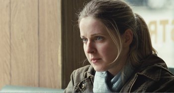 Movie still from “The Angels' Share” (2012), directed by Ken Loach – A young woman with blue eyes looking into the distance; Close Up shot, Over the shoulder angle