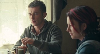 Movie still from “The Angels' Share” (2012), directed by Ken Loach – A man and a woman sitting in front of a window; Medium shot, Over the shoulder angle