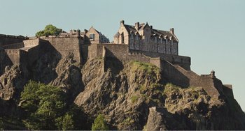 Movie still from “The Angels' Share” (2012), directed by Ken Loach – A castle on top of a hill with a sky background; Extreme Wide shot, Low angle