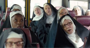 Movie still from “The Angels' Share” (2012), directed by Ken Loach – A group of nuns sitting on top of a bus; Medium shot, Low angle