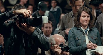 Movie still from “The Angels' Share” (2012), directed by Ken Loach – A man taking a picture of a crowd of people; Medium shot, Over the shoulder angle