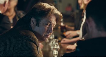 Movie still from “The Angels' Share” (2012), directed by Ken Loach – A man sitting at a table in front of two other people; Close Up shot, Over the shoulder angle
