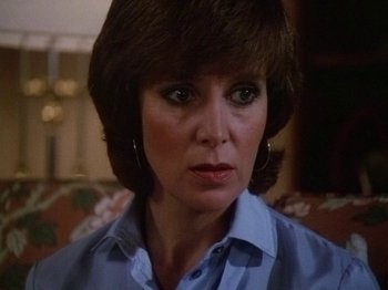 Movie still from “The Appointment” (1982), directed by Lindsey C. Vickers – A person wearing a blue shirt; Close Up shot, High angle