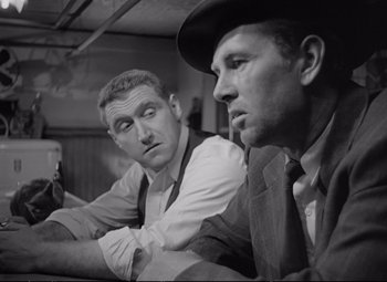 Movie still from “The Asphalt Jungle” (1950), directed by John Huston – A black - and - white photo of two men sitting next to each other; Close Up shot, Low angle