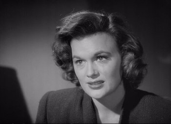 Movie still from “The Asphalt Jungle” (1950), directed by John Huston – An old photo of an older woman in a black jacket; Close Up shot, High angle