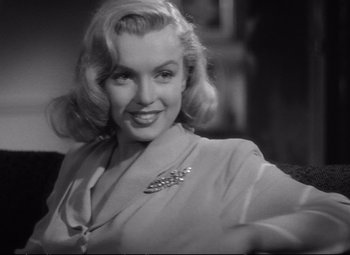 Movie still from “The Asphalt Jungle” (1950), directed by John Huston – A black - and - white photo of marilyn monroe; Close Up shot, Over the shoulder angle
