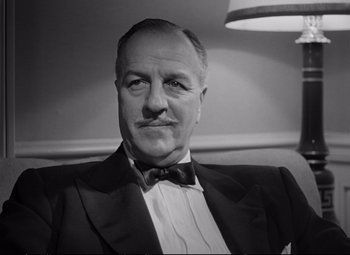 Movie still from “The Asphalt Jungle” (1950), directed by John Huston – An older man wearing a suit and bow tie; Close Up shot, Low angle